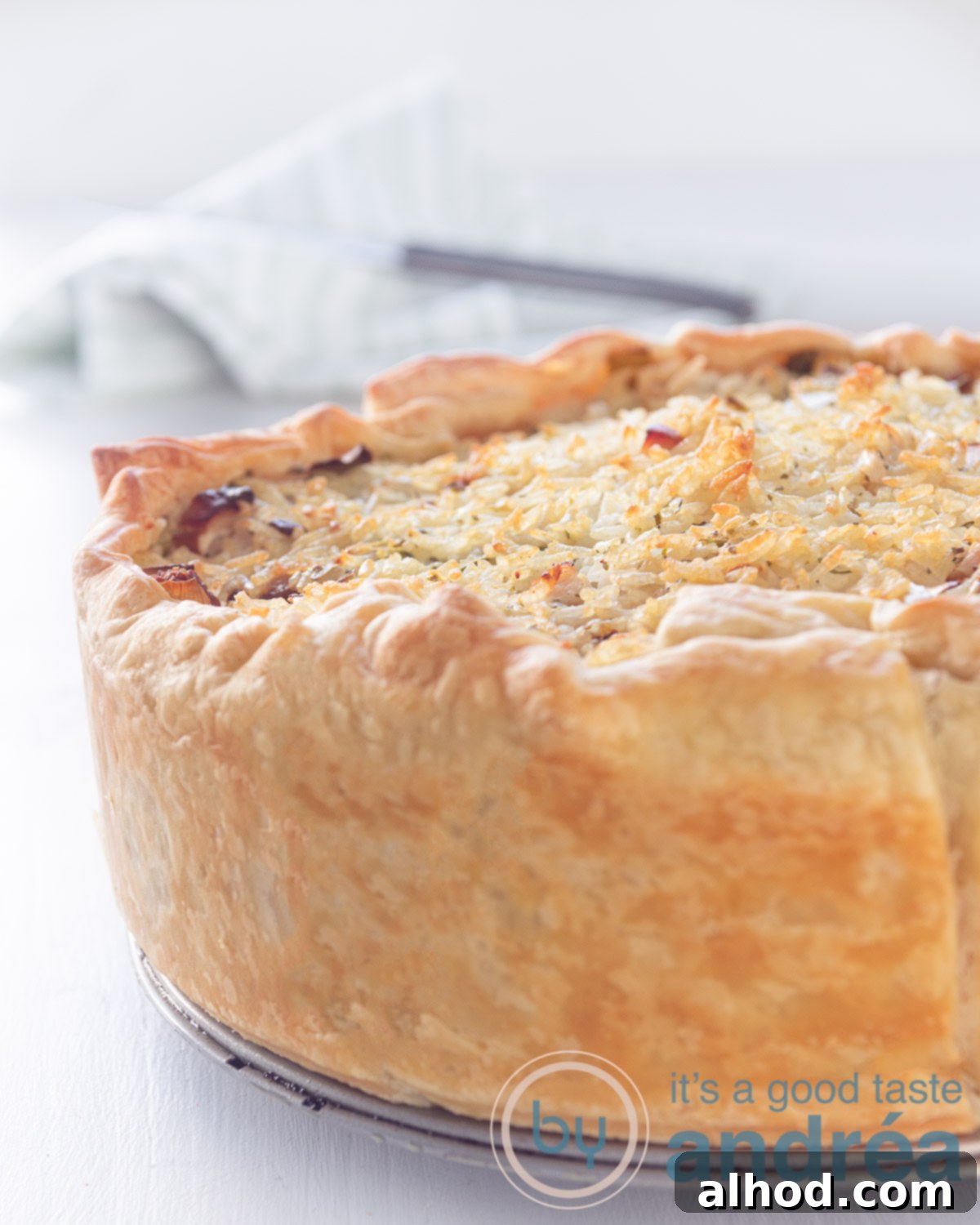 Golden Chicken Leek Rice Quiche 2 Half a quiche filled with smoked chicken, leek and rice, golden brown baked on a white background