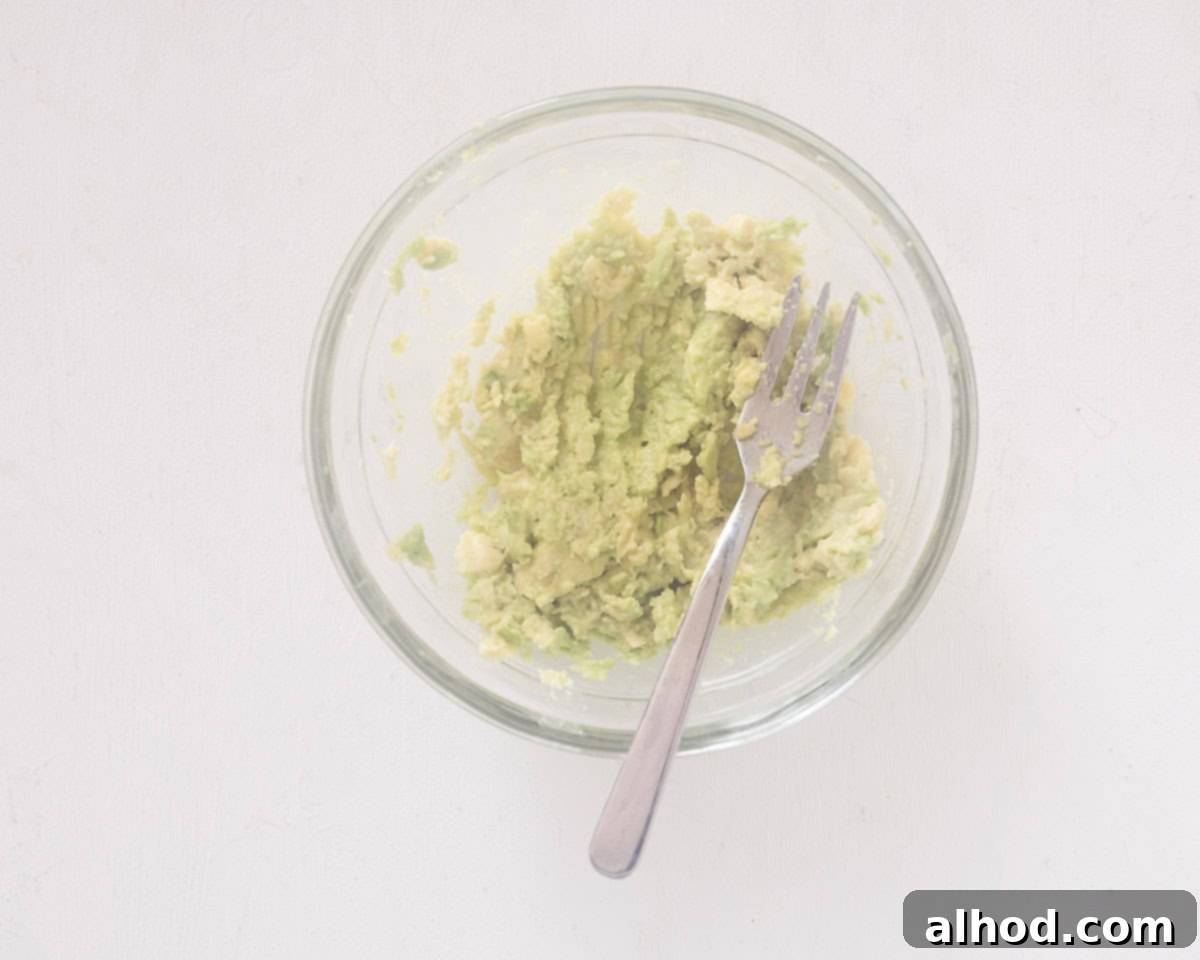 Silky Avocado Deviled Eggs 4 In a glass bowl mashed avocado