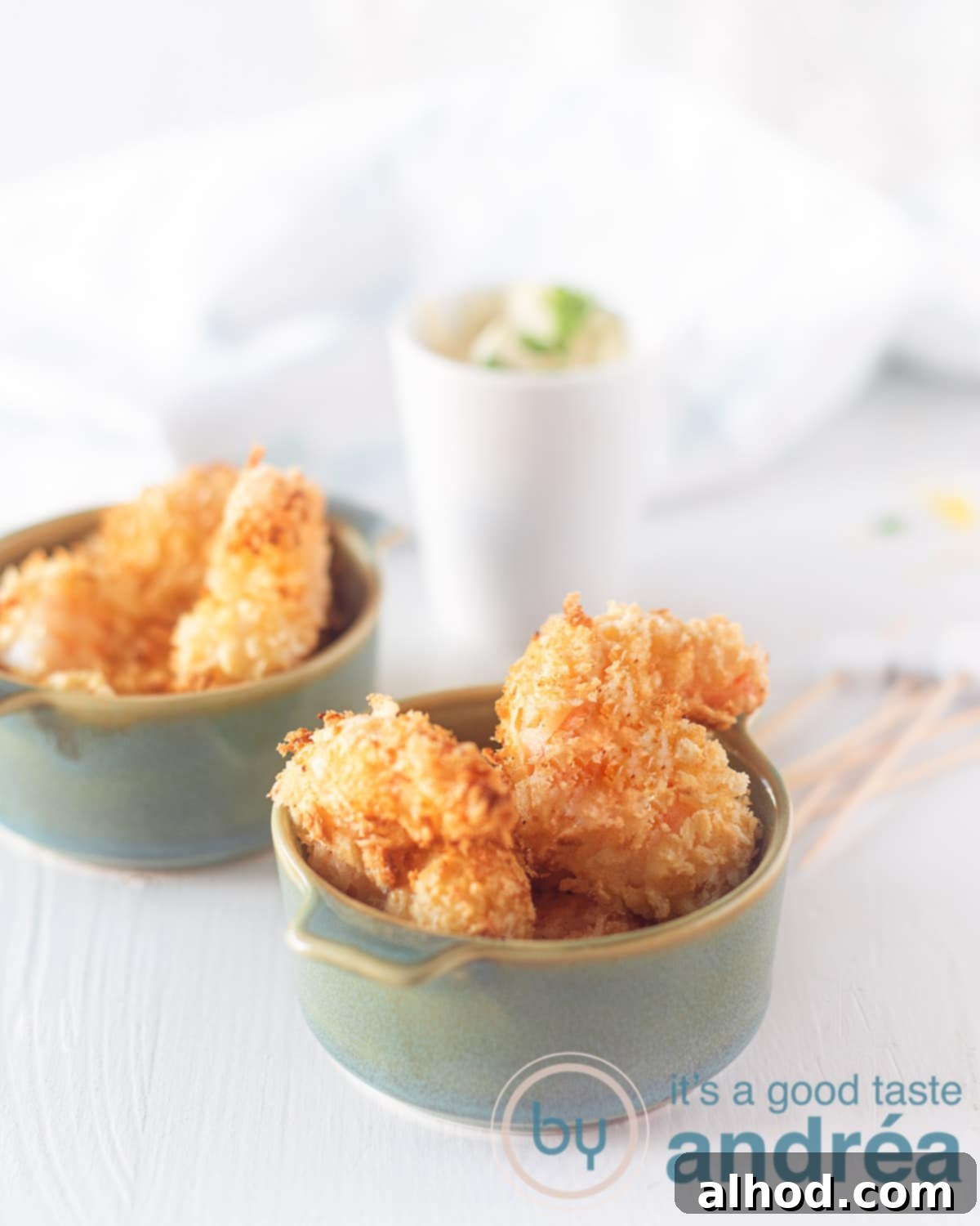 Crispy Garlic Shrimp Bites with Tangy Lemon Aioli 6 Two blue bowls filled with popcorn shrimp. Aioli dip in the background.