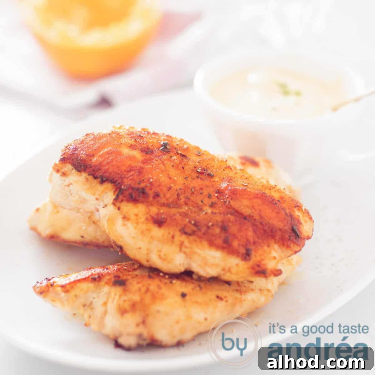 Easy 20-Minute Orange Thyme Skillet Chicken 4 Chicken breast filet with orange sauce on a white plate. A square photo