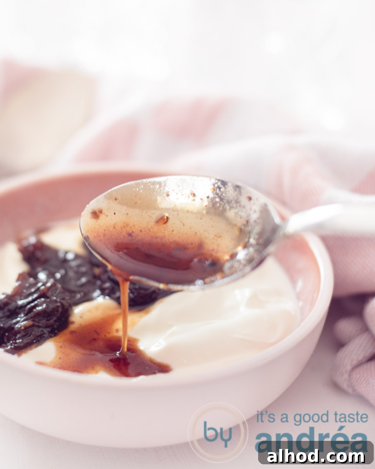 A close-up shot of Greek yogurt with spiced plums, showing the vibrant colors and inviting textures of the compote on the creamy white yogurt.