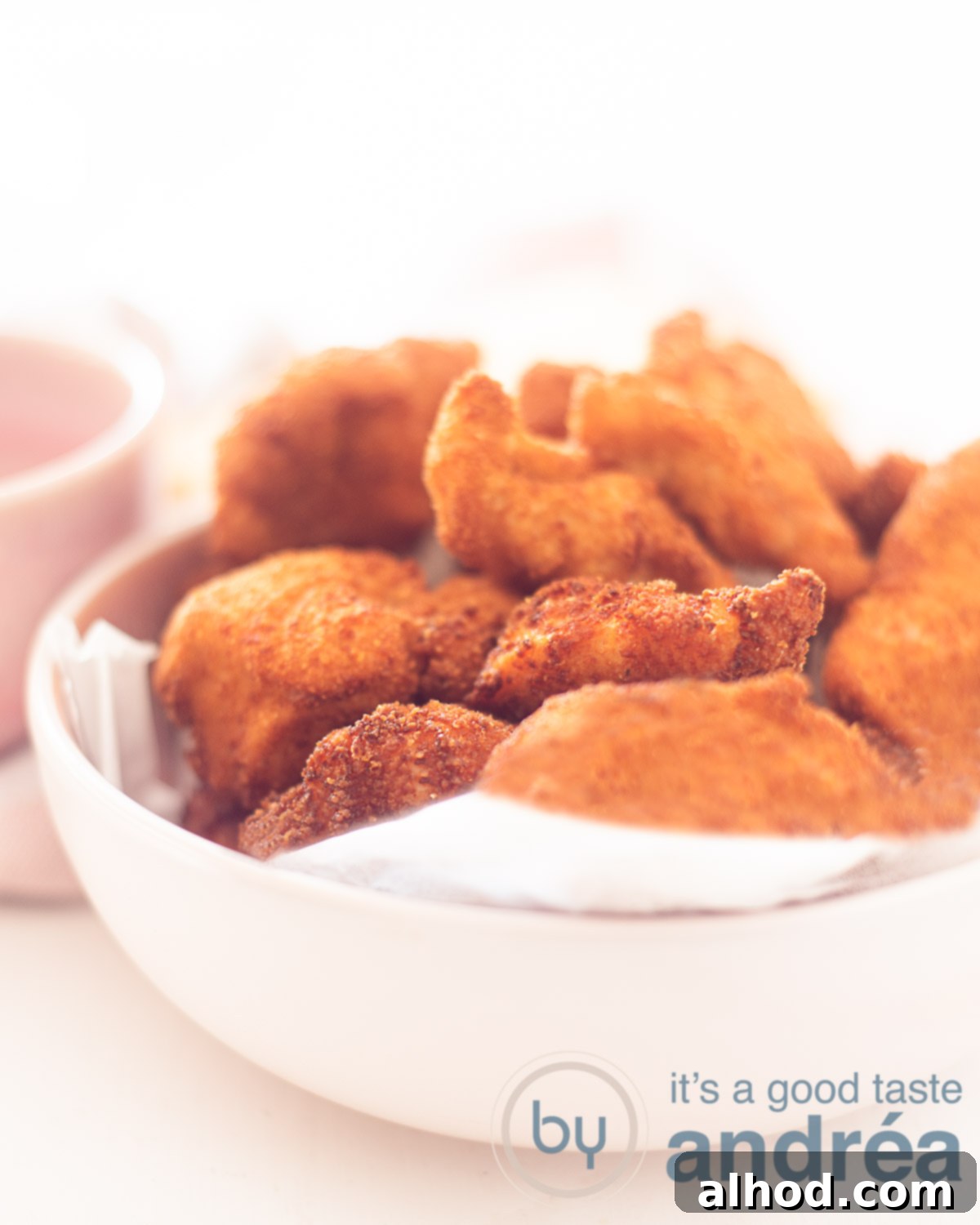 Parmesan Crusted Chicken Nuggets 5 Close-up of golden-brown crispy chicken nuggets with Parmesan cheese, ready to be served.