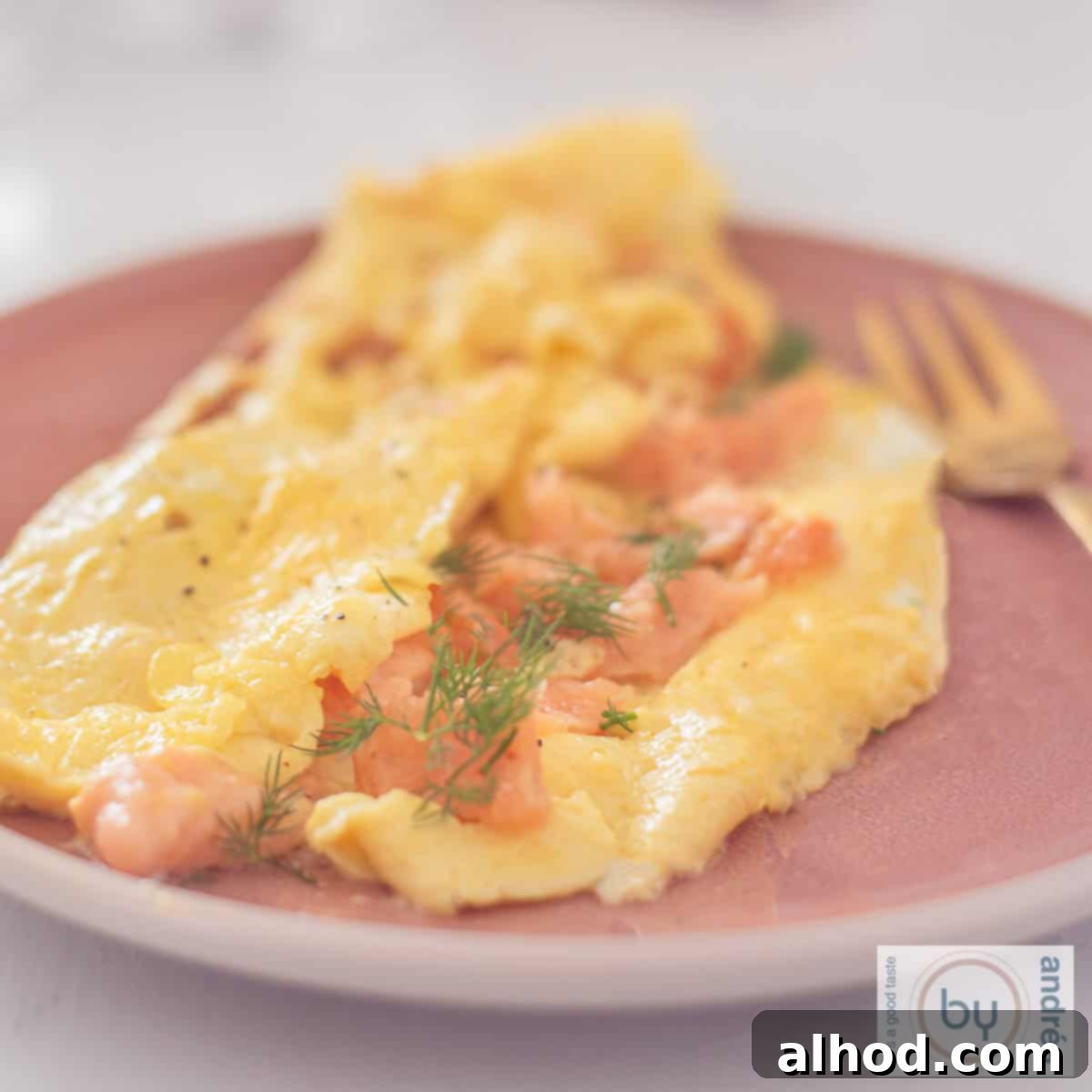 Gourmet Smoked Salmon Omelette 4 Omelette with smoked salmon and chives on a pink plate, A square picture