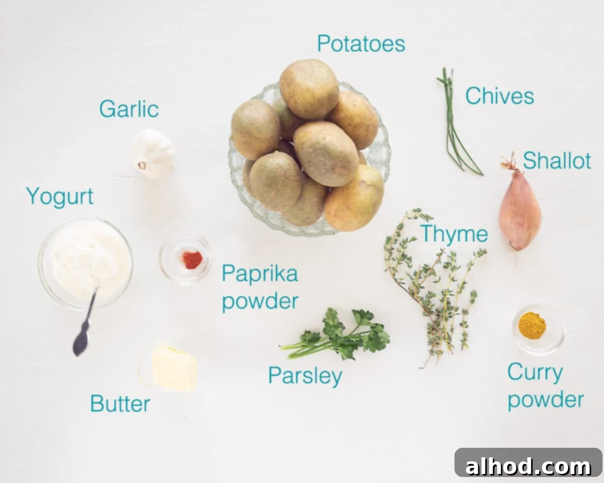 A flat lay image showing fresh ingredients for seasoned baked potatoes with yogurt garlic sauce, including potatoes, herbs, onion, butter, curry powder, and a bowl of yogurt.