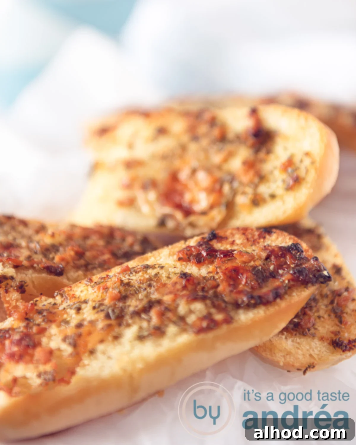 Ultimate Parmesan Garlic Bread 5 Homemade Garlic buns on a white background, baked golden brown and perfectly crispy.
