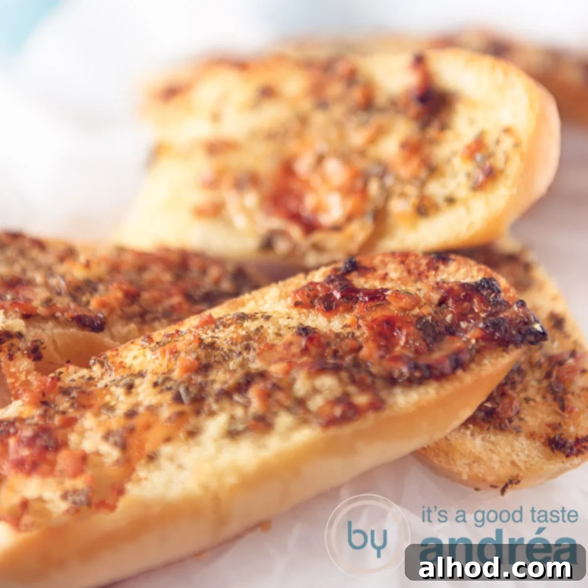 Ultimate Parmesan Garlic Bread 6 A square photos with garlic buns on a white background