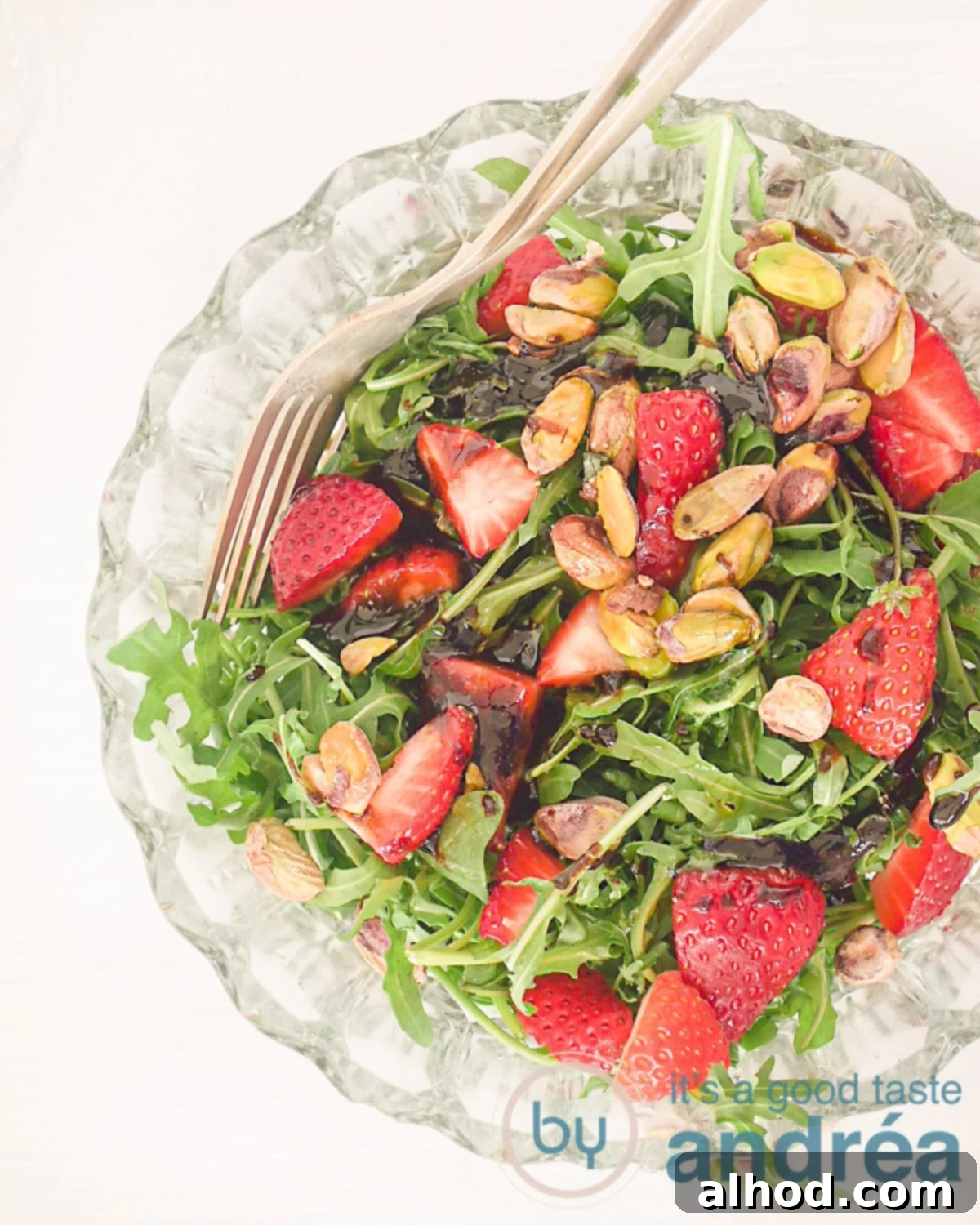 Strawberry Pistachio Salad 2 A photo from above of a glass bowl filled with strawberry salad and pistachio nuts
