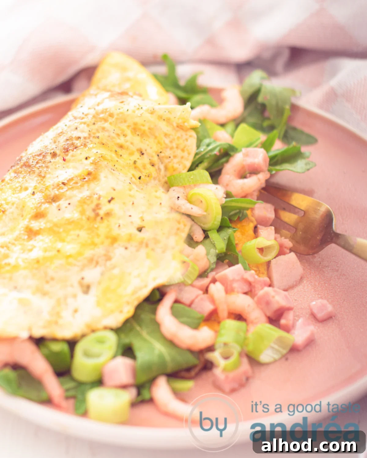 A vibrant pink plate holds a perfectly folded omelette, generously filled with plump shrimp, diced ham, fresh arugula, and finely chopped spring onions. A fork is poised, piercing the rich filling, inviting a taste.