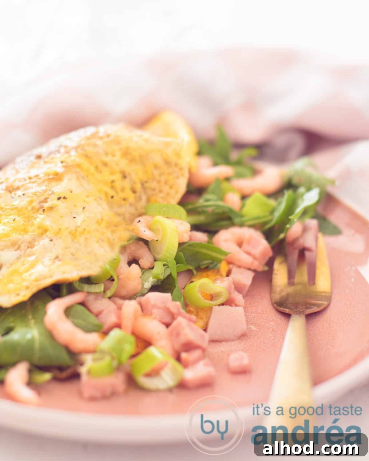 Savory Shrimp Omelette 5 A beautifully presented Shrimp Omelette recipe rests on a patterned towel, highlighting its appealing presentation.