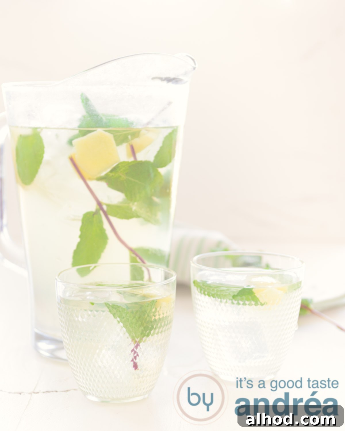Craft Your Own Ginger Iced Tea 4 A glass and jar filled with ginger iced tea. Added are mint and slices ginger. A white background