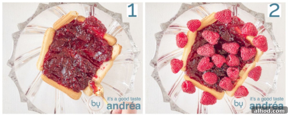 A layer of raspberry jam spread over ladyfingers, followed by fresh raspberries, creating a vibrant base for the trifle.