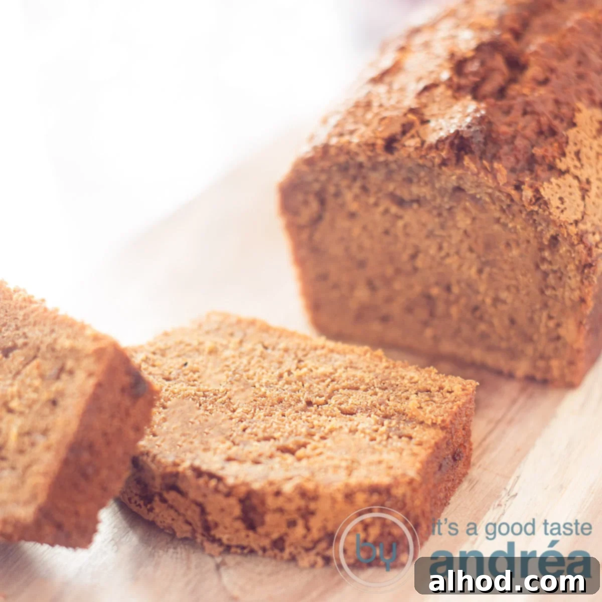 Dutch Gingerbread Loaf 5 a square photo of peperkoek, two slices off on a wooden board