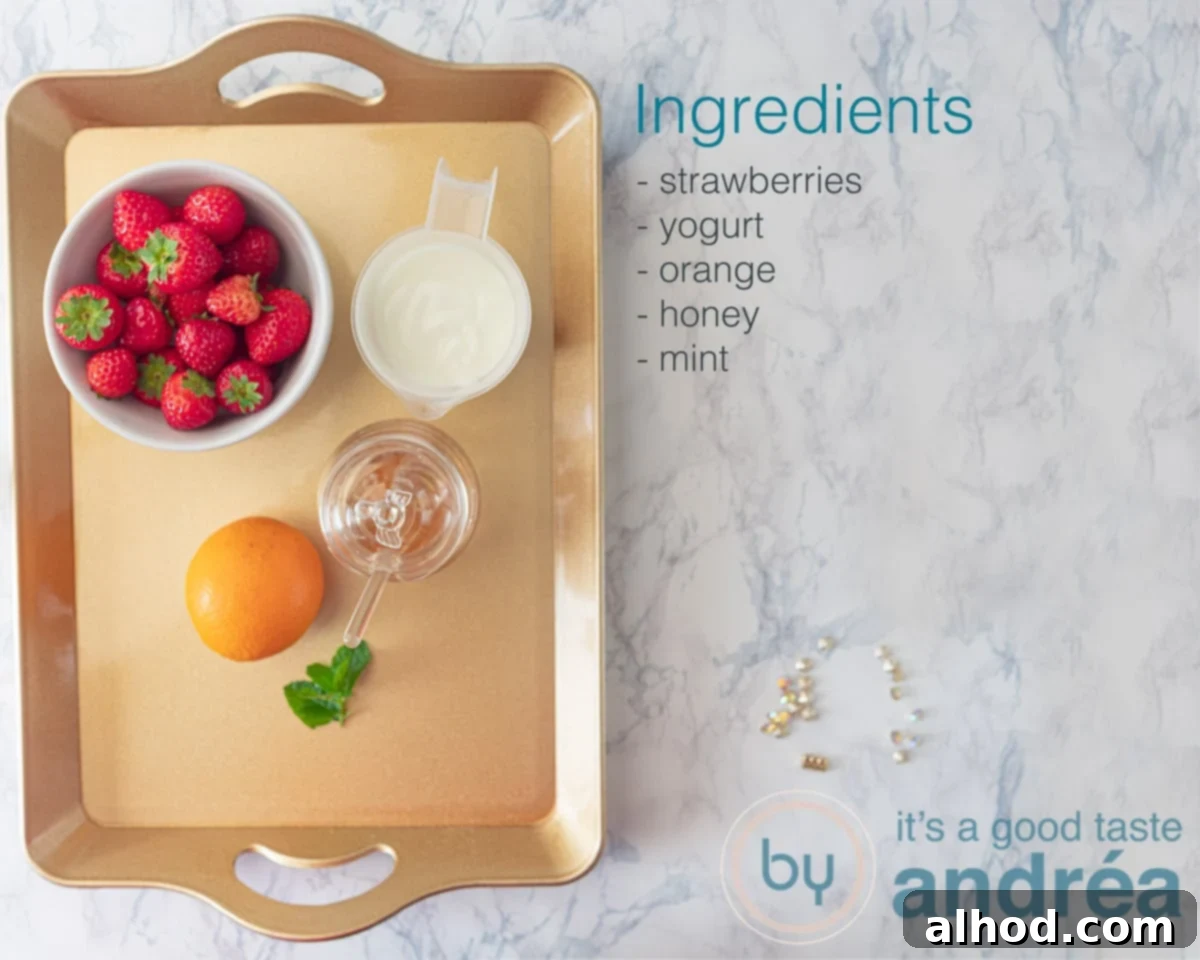 Zesty Berry Orange Blend 3 A selection of fresh ingredients for a strawberry orange smoothie, including bright red strawberries, a whole orange, a container of Greek yogurt, a drizzle of honey, and fresh mint leaves.