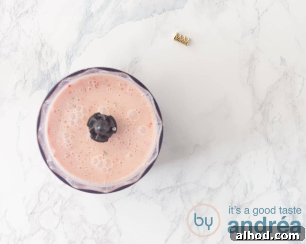 Zesty Berry Orange Blend 7 A blender in action, actively mixing the ingredients to create a smooth and creamy strawberry orange smoothie.