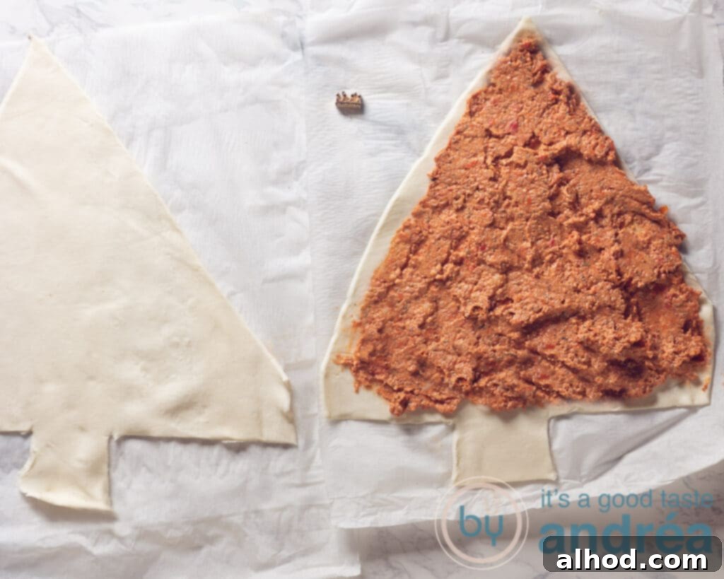 Festive Pesto Puff Pastry Christmas Tree Recipe 5 Spreading red pesto on puff pastry cut into a Christmas tree shape