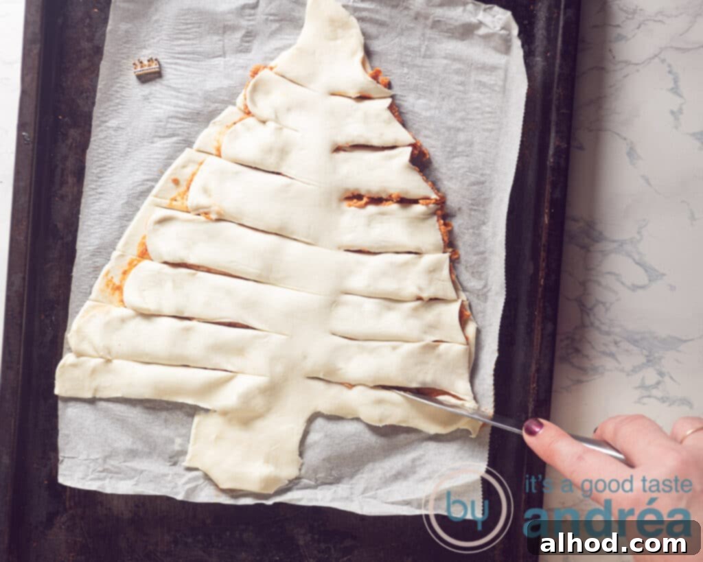 Festive Pesto Puff Pastry Christmas Tree Recipe 6 Cutting horizontal branches into the layered puff pastry tree