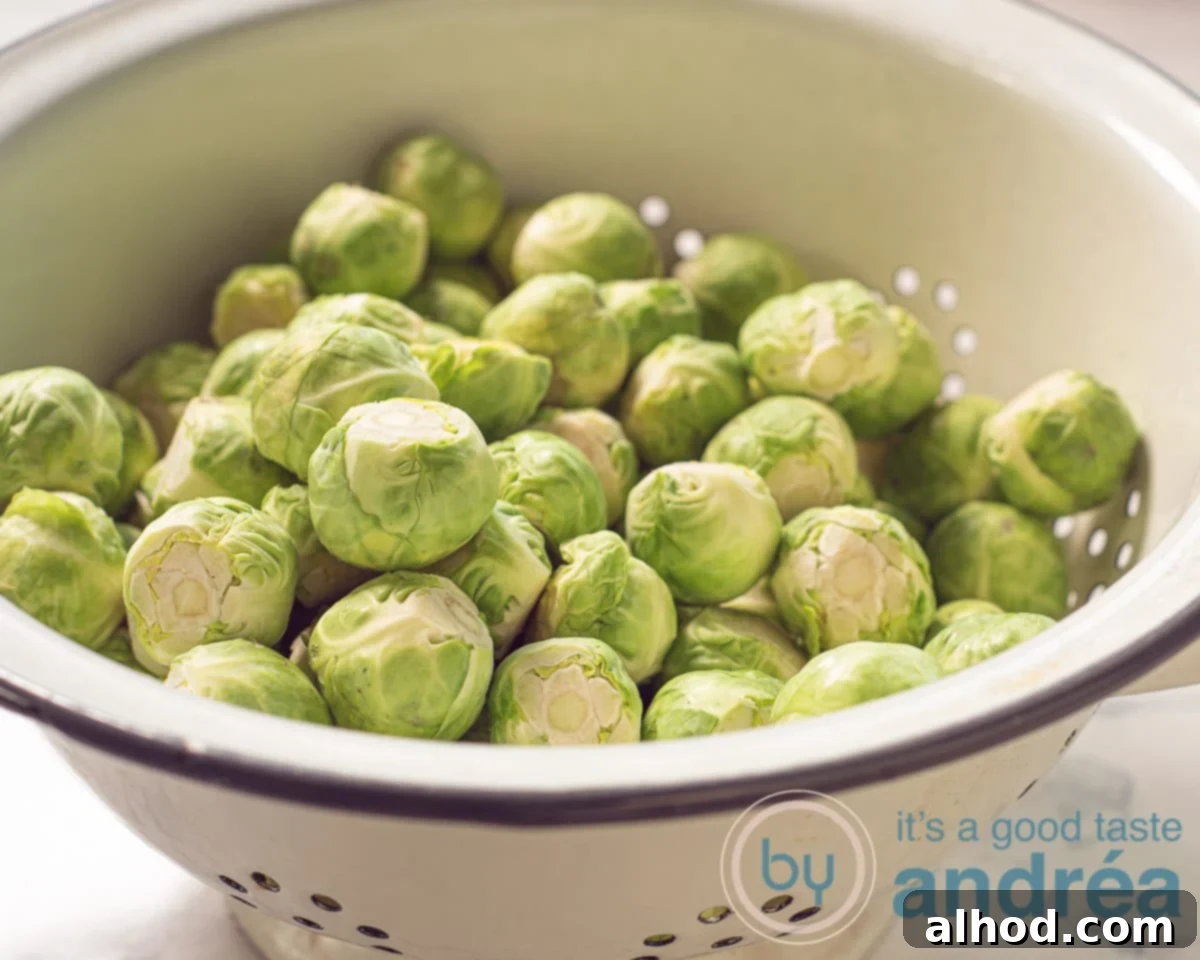 Caramelized Bourbon Brussels and Crispy Bacon 4 Freshly cleaned Brussels sprouts in a colander, ready for cooking.