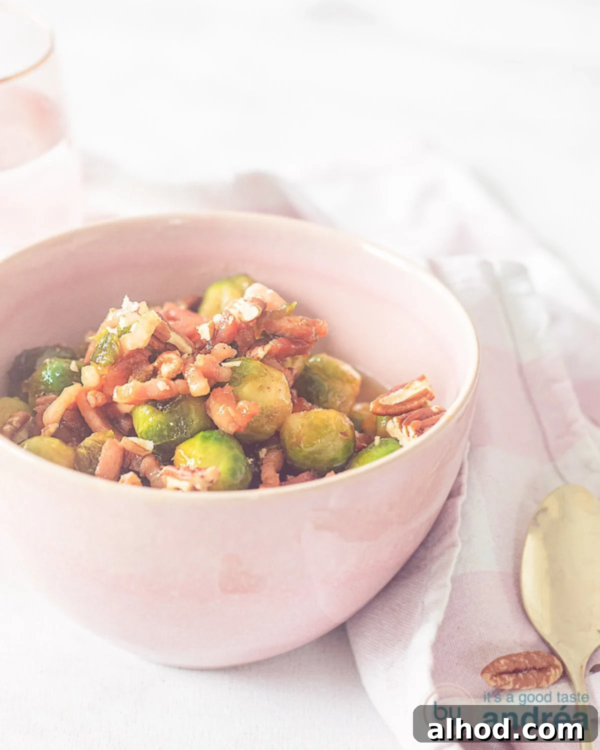 Caramelized Bourbon Brussels and Crispy Bacon 8 A beautifully presented bowl of Bourbon-glazed Brussels sprouts with crispy bacon and toasted pecans.