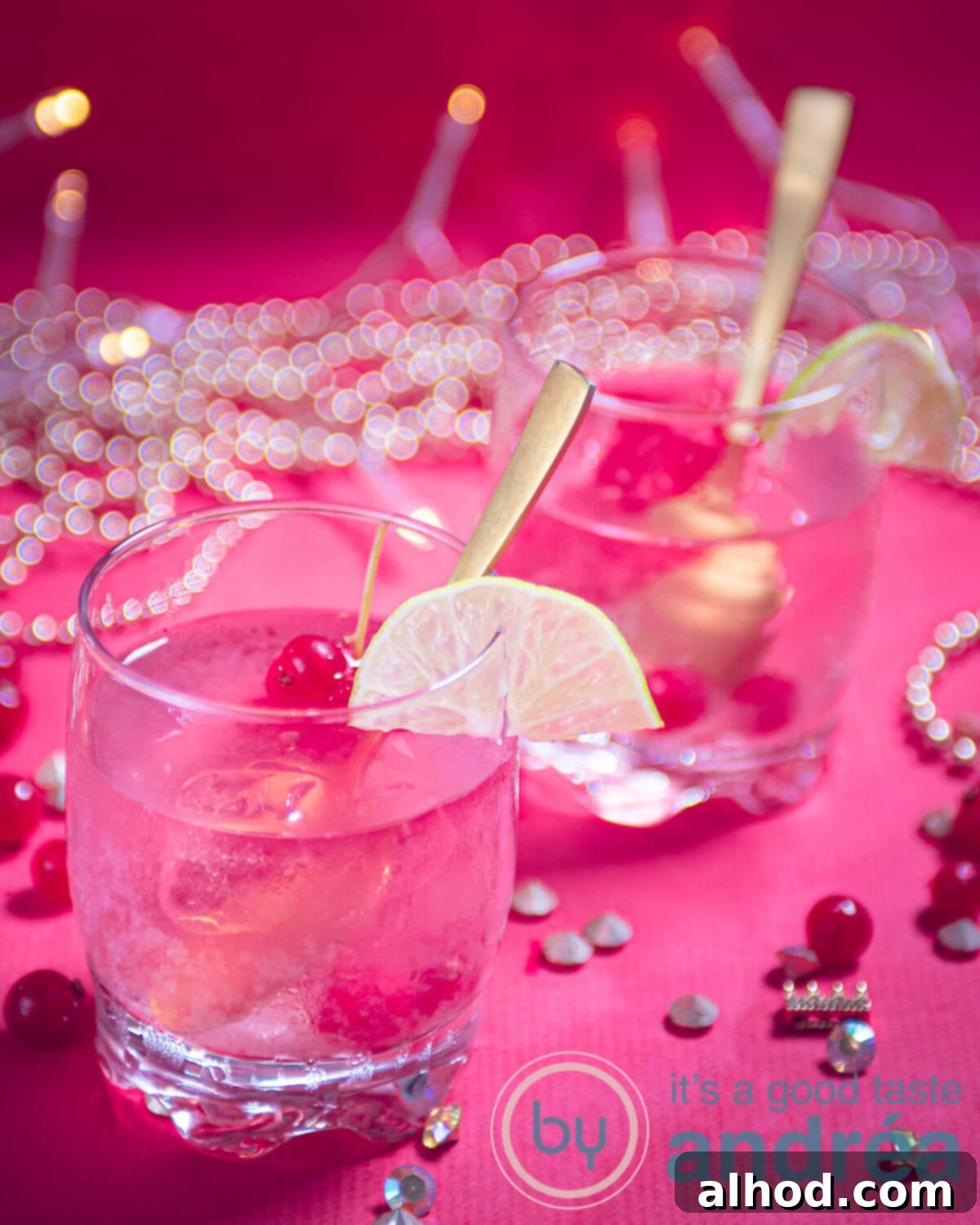 Simple and Refreshing Red Currant Caipirinha 8 Two glasses of Red Currant Caipirinha cocktail, garnished with fresh lime wedges and red currants, on a contrasting background.