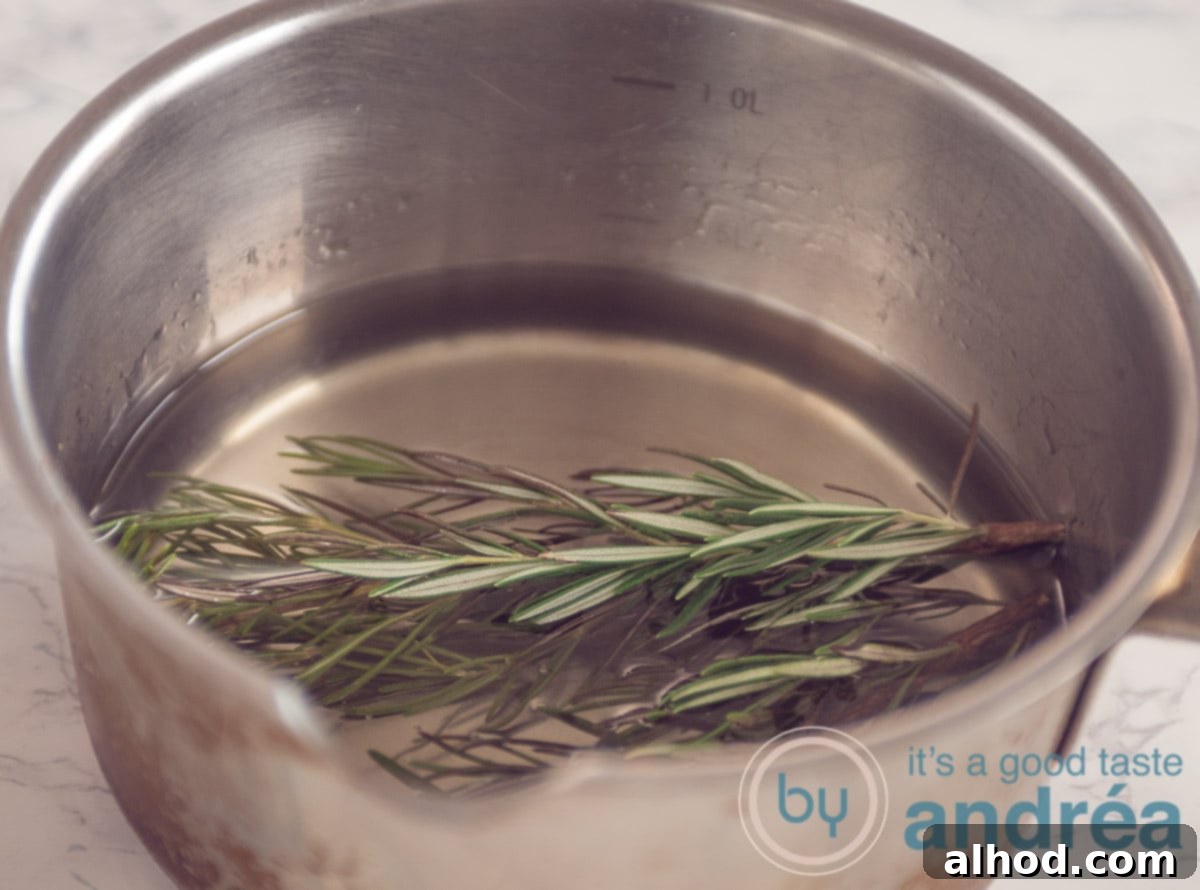 Grapefruit and Rosemary Sparkling Mocktail 4 rosemary in a pan with sugar water