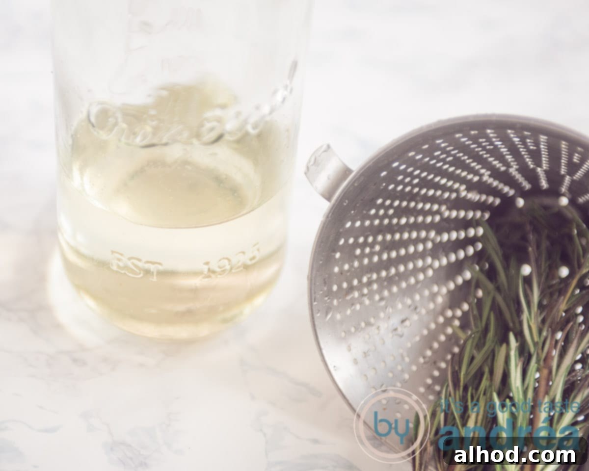 Grapefruit and Rosemary Sparkling Mocktail 5 rosemary sugar water and a sieve with rosemary