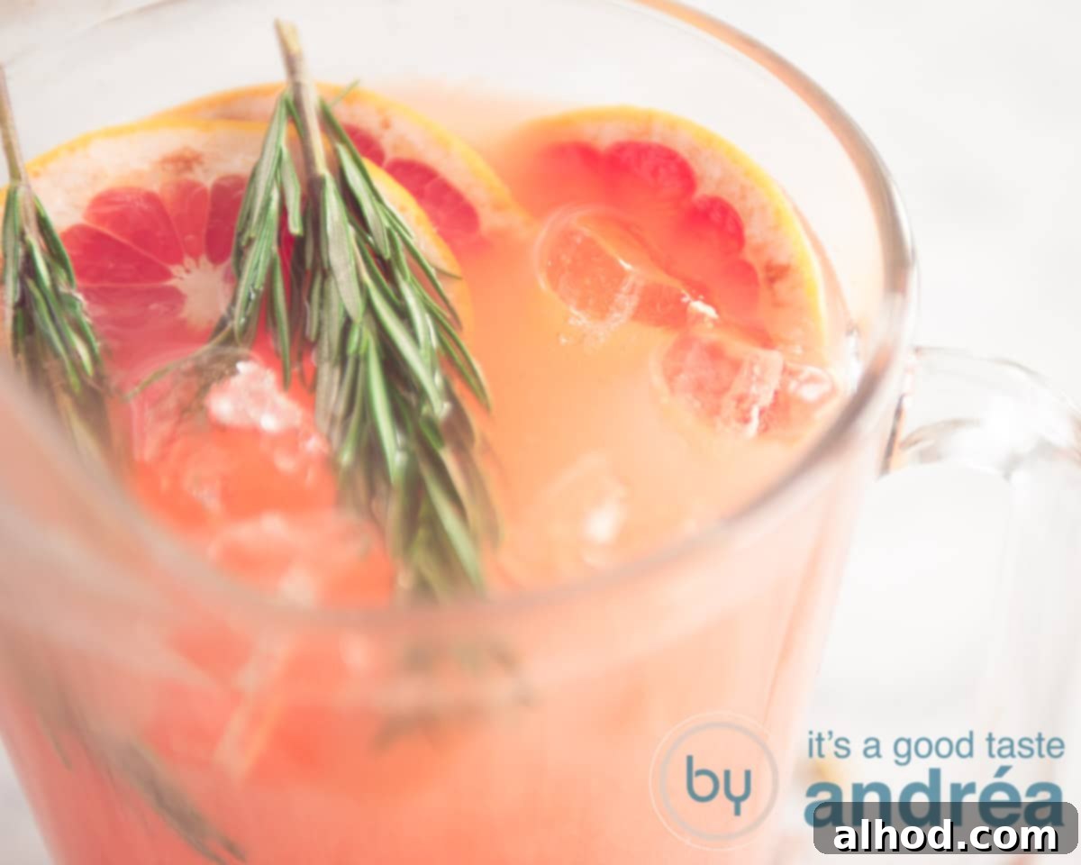 Grapefruit and Rosemary Sparkling Mocktail 7 A jar of grapefruit mocktail with garnish