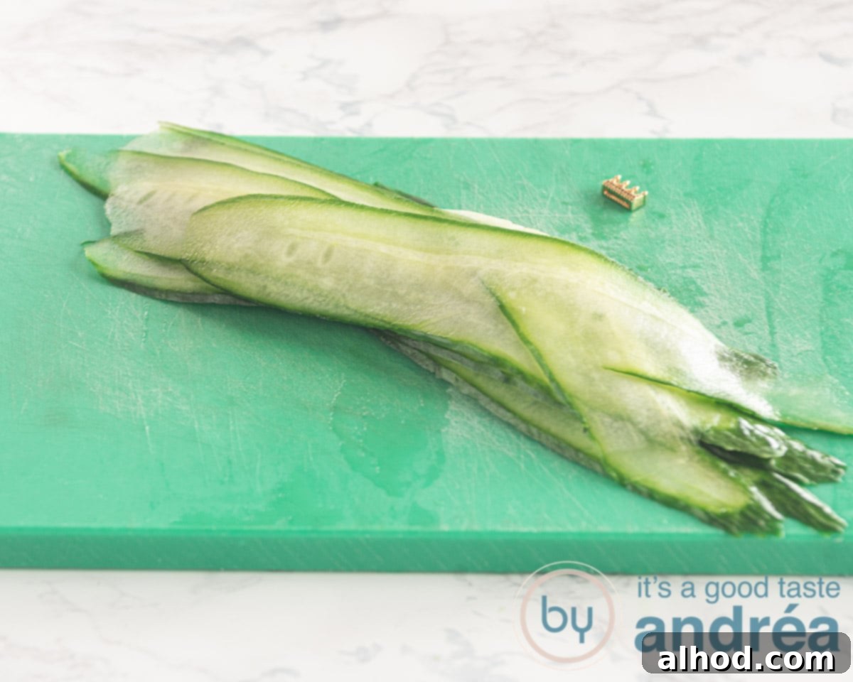 Effortless Smoked Salmon Cucumber Salad 7 Thin cucumber ribbons on a green cutting board