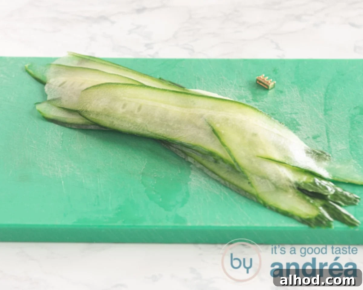 Effortless Smoked Salmon and Cucumber Salad 7 Freshly sliced cucumber ribbons neatly arranged on a green cutting board, ready for presentation in the salad.