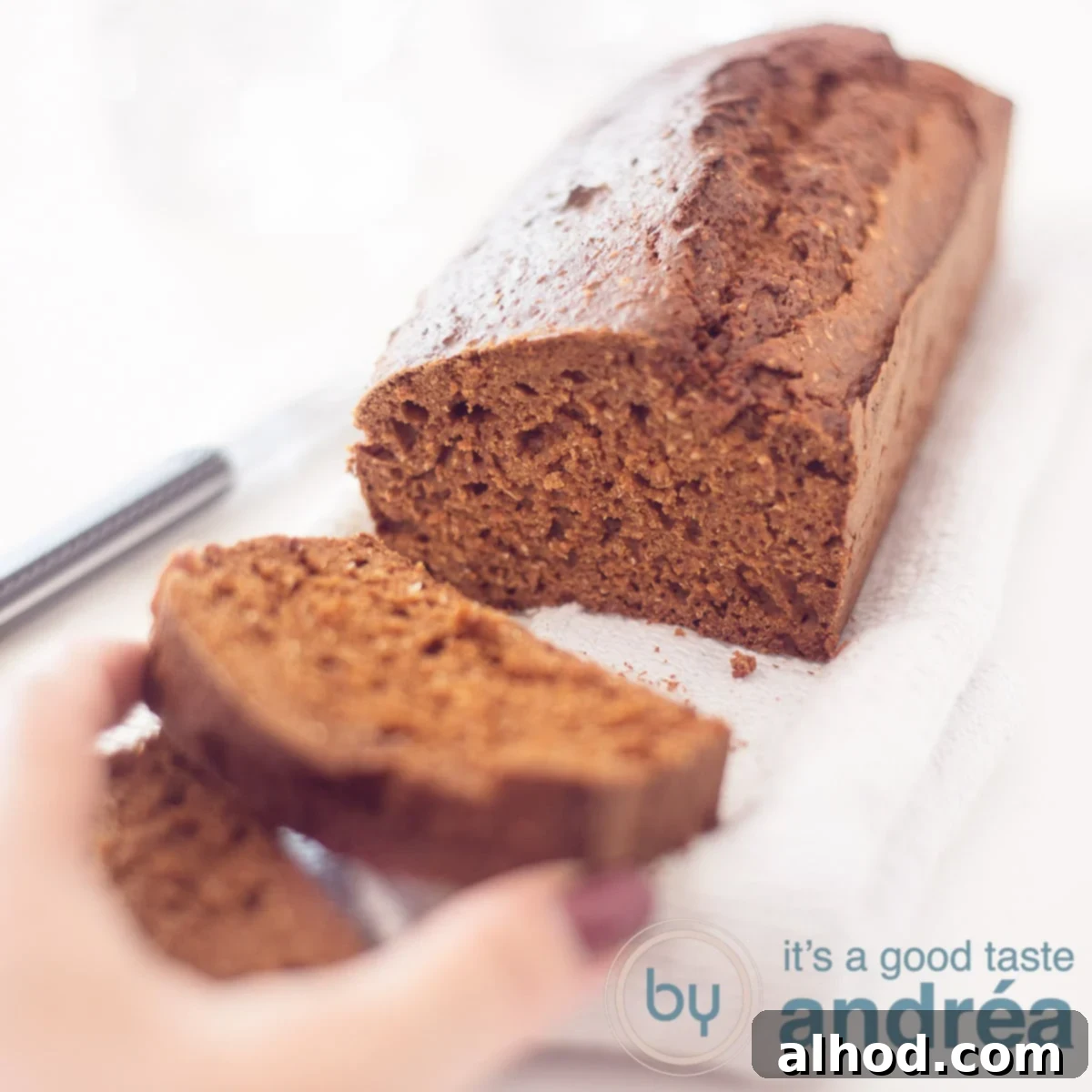Guilt-Free Sweet Morning Cake 6 A square photo with a gingerbread without refined sugars. A slice cut off that is taken. Everything on a white background, perfect for a healthy breakfast.