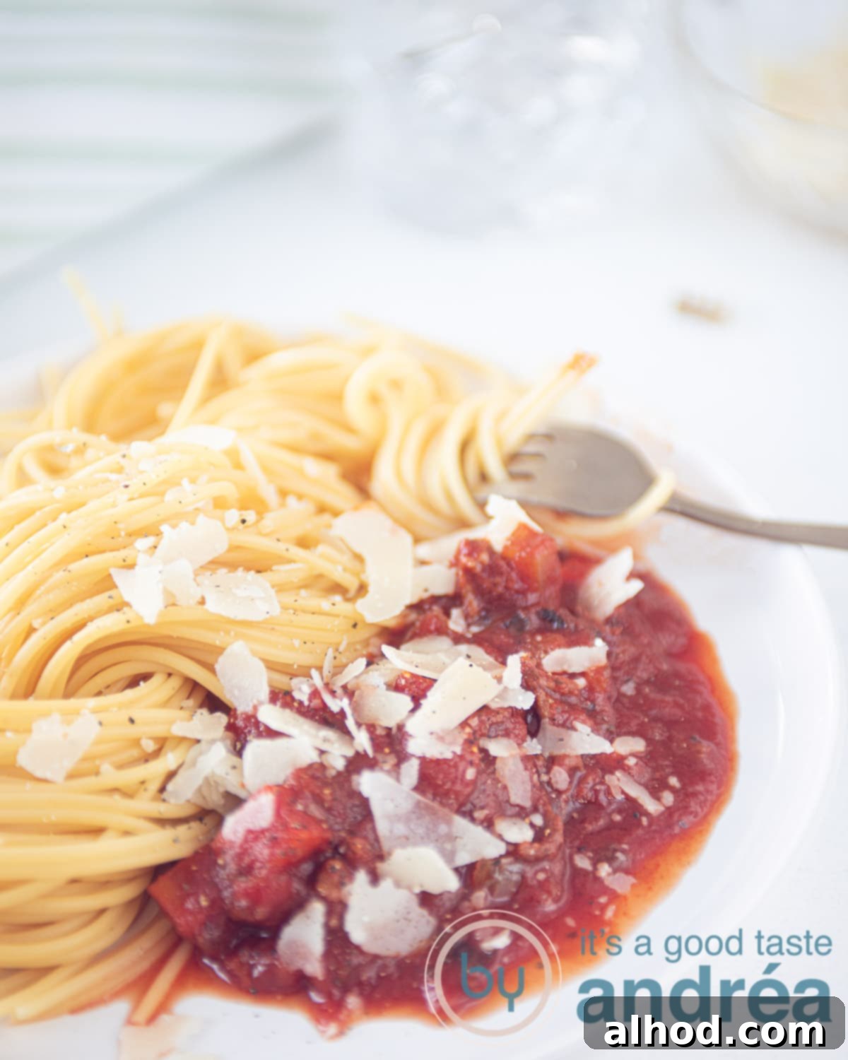 Rich Slow Cooker Beef Spaghetti Sauce 5 slowcooker pasta sauce with ground beef on a white plate with some spaghetti