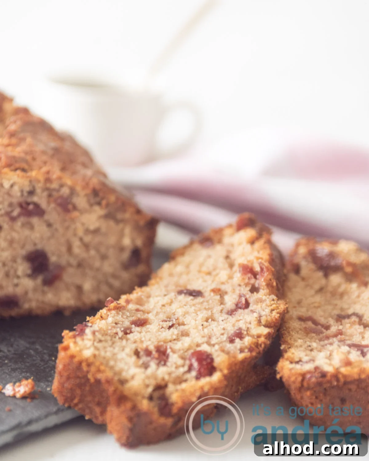 Sweet and Tart Cranberry Walnut Crumb Cake 3 a cranberry walnut coffee cake on a silver platter. Two slices cut off.