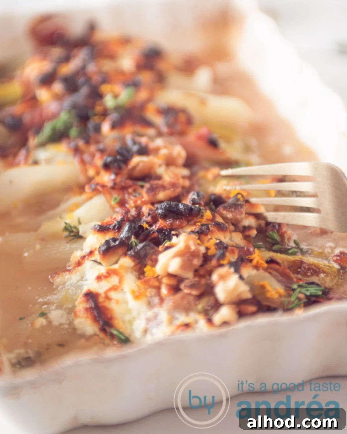 Belgian Endive Bake with Ham and Chevre 9 a fork taking some chicory wrapped in Prosciutto, goat cheese and orange