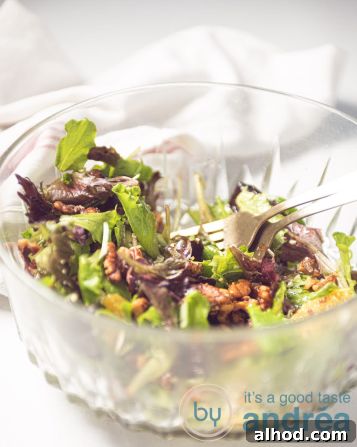 Spicy Blue Cheese Salad with Zesty Orange and Toasted Walnuts 9 a glass bowl filled with a salad with oranges, walnuts, and blue cheese