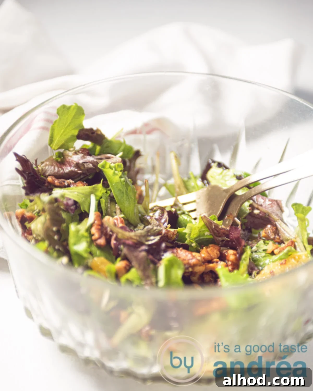 Spicy Blue Cheese Salad with Walnuts and Orange 9 a glass bowl filled with a salad with oranges, walnuts, and blue cheese
