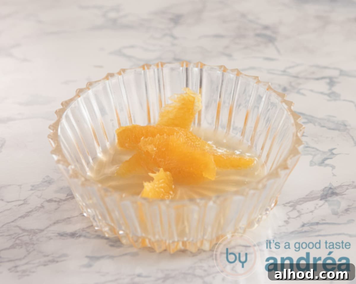 Spicy Blue Cheese Salad with Walnuts and Orange 5 Slices of orange being segmented over a bowl to collect juice.