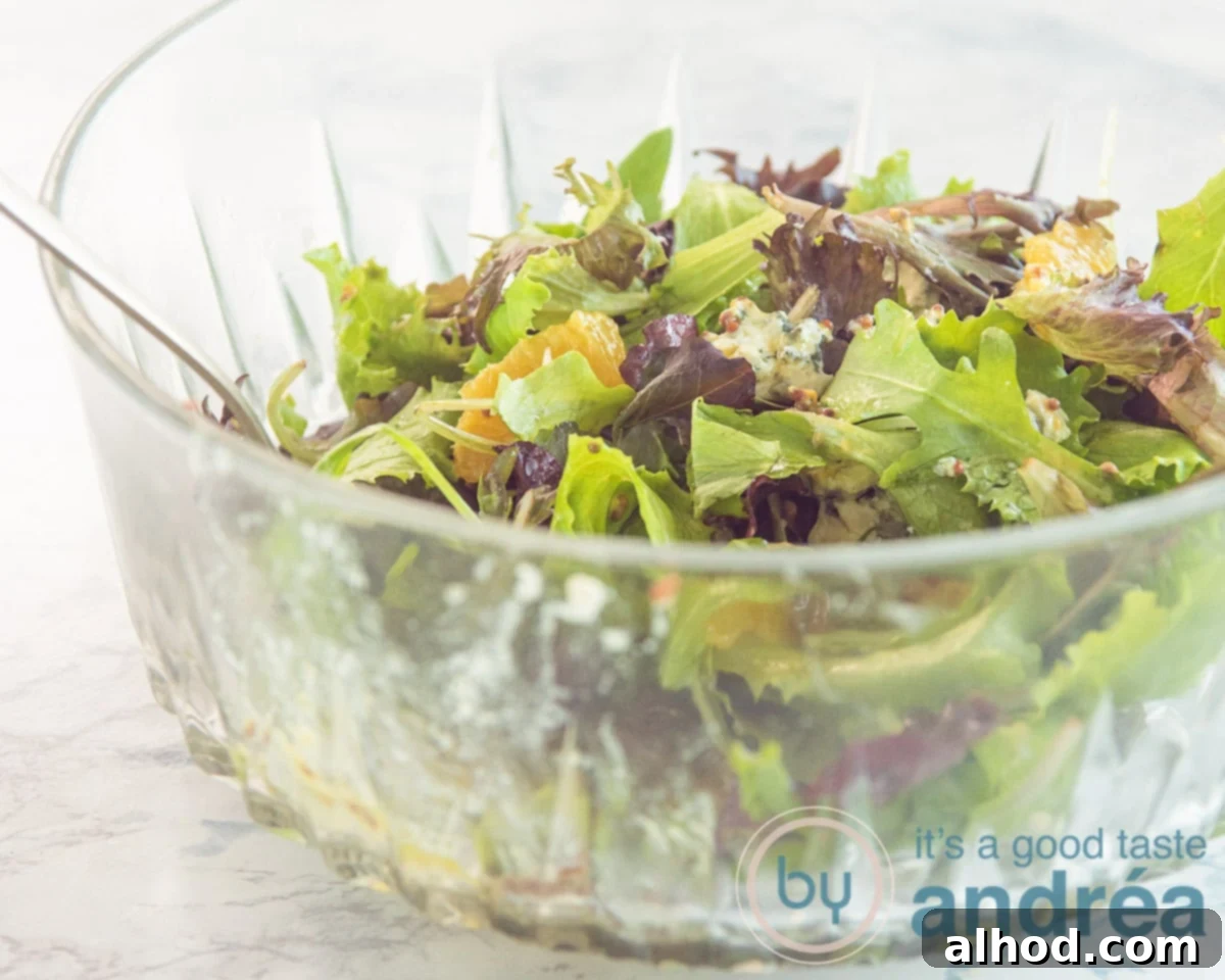 Spicy Blue Cheese Salad with Walnuts and Orange 7 Assembling a colorful orange salad with lettuce, blue cheese, and dressing.
