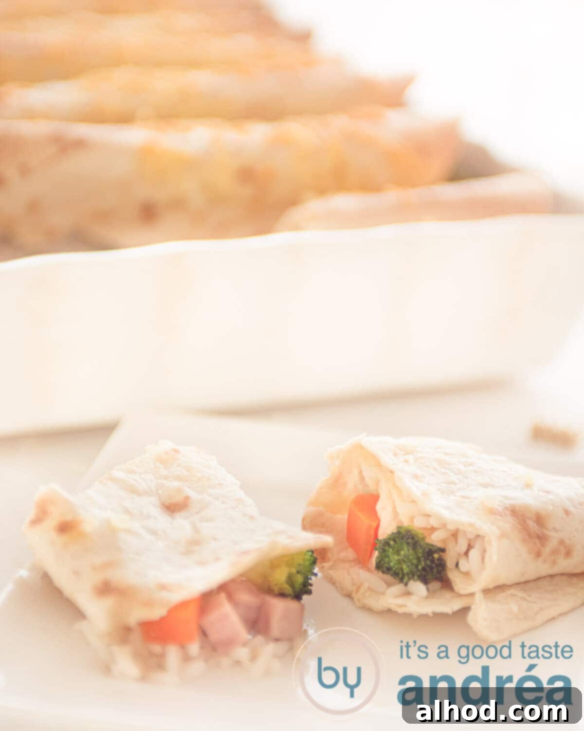 Delicious Ham and Carrot Rice Bake 8 Two half-cut baked tortilla wraps revealing the fluffy rice, tender carrots, crisp broccoli, and savory ham filling, with a full casserole in the background