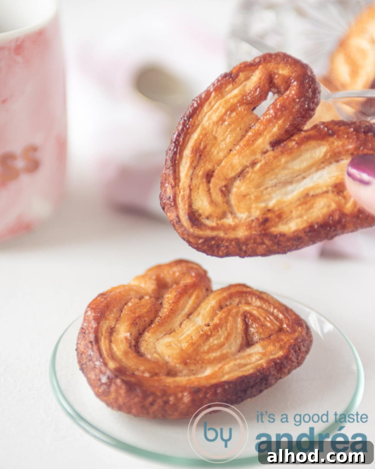 Simple 3-Ingredient Cinnamon Palmiers 8 a hand holding an elephant ear cookie and one on a plate