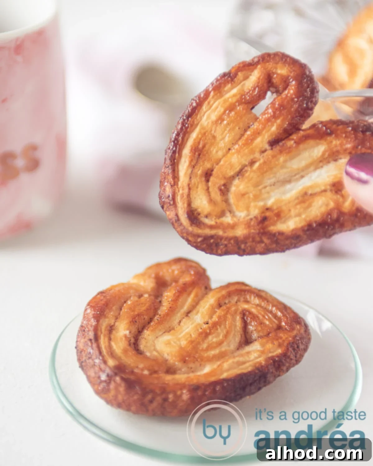 Simple 3-Ingredient Cinnamon Palmiers 9 a hand holding an elephant ear cookie and one on a plate