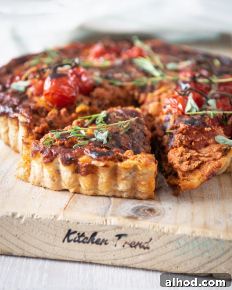 A close-up shot of a rich Bolognese quiche, showcasing the hearty meat sauce baked into a savory pie crust, ready to be served.
