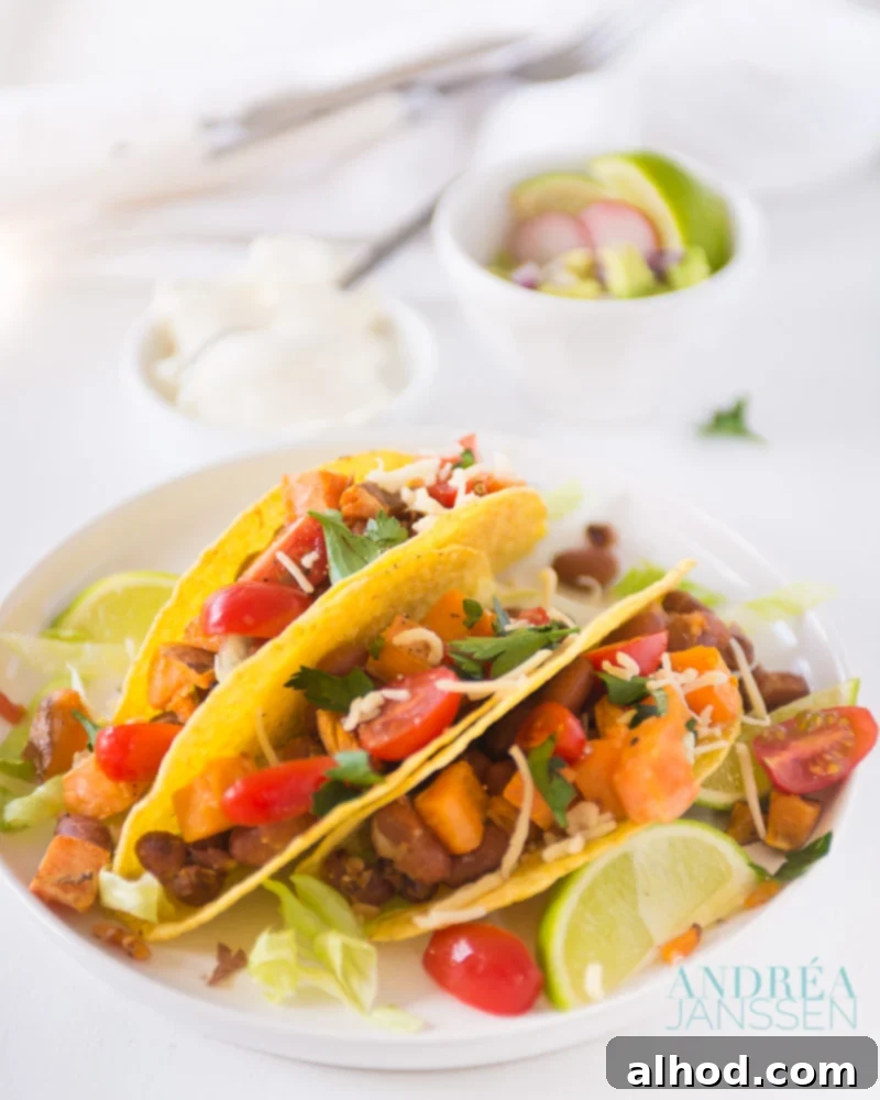 11 Amazing Mexican Recipes to Ignite Your Home Fiesta 13 A vibrant vegetarian taco, generously filled with tender sweet potato and flavorful beans, showcasing a healthy and delicious meal option.