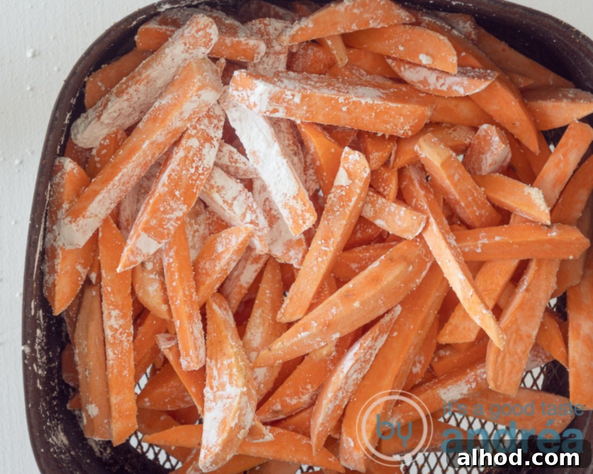 Crispy Air Fryer Sweet Potatoes with Creamy Dipping Sauce 6 Spiced sweet potato fries in the air fryer tray