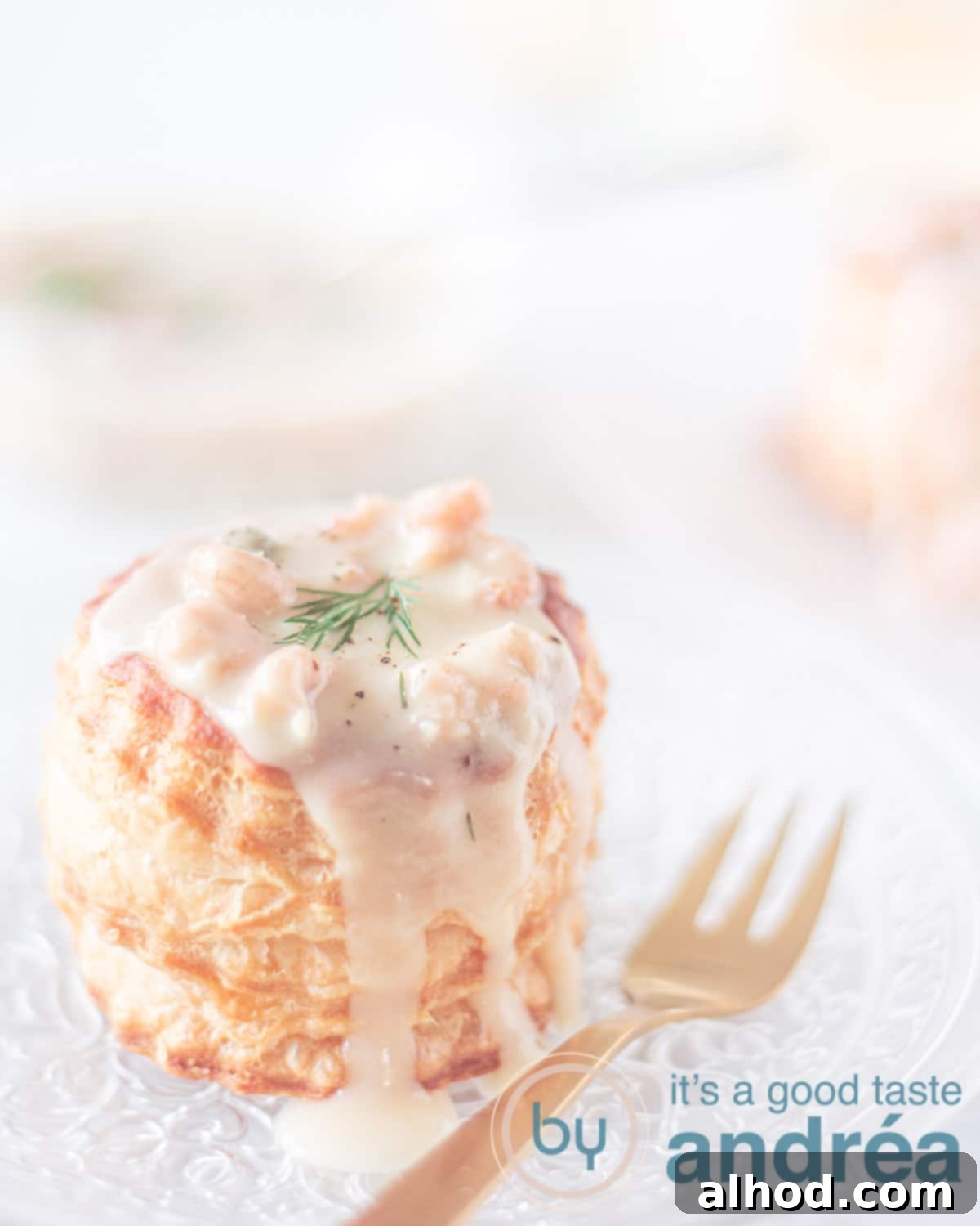 Dutch Shrimp Ragout Puffs 6 a puff pastry basket filled with shrimp gravy and topped with dill on a glass plate