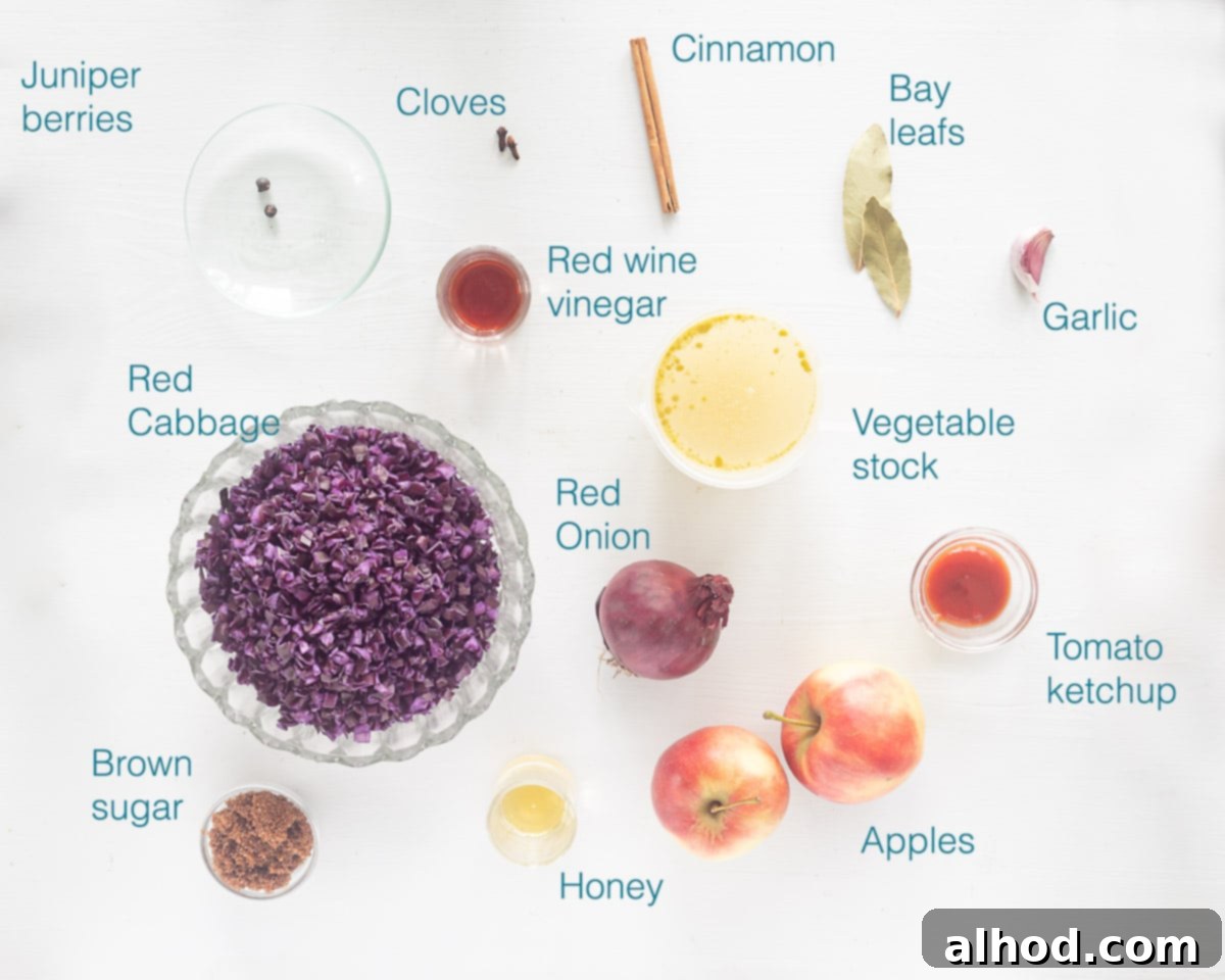 Sweet and Sour German Red Cabbage 3 A flat lay photo showing all the ingredients for Crockpot Red Cabbage German Style neatly arranged on a white background, including sliced red cabbage, apples, onions, and various spices.