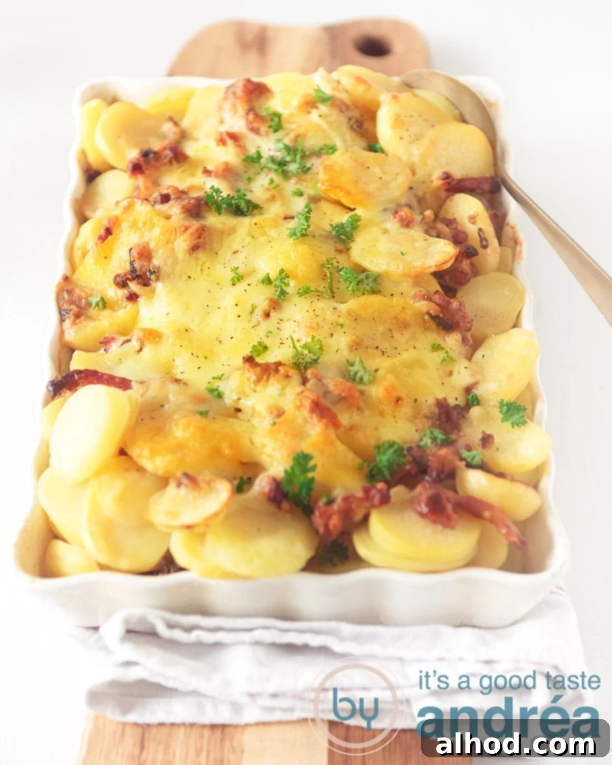 Creamy Dutch Potato and Ground Beef Casserole 2 Photo from above of a white baking dish on a wooden board. Filled with potatoes, au gratin, bacon, leek and minced meat