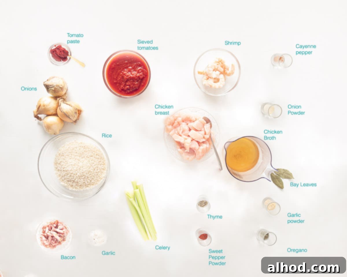 Classic Chicken, Shrimp, and Sausage Jambalaya Recipe 3 Ingredients for Chicken Jambalaya laid out on a white surface, including chicken, sausage, shrimp, rice, vegetables, and spices.