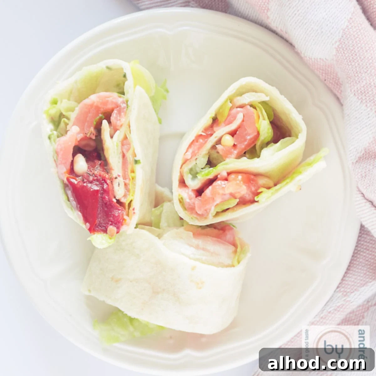 10-Minute Smoked Salmon Pinwheels 6 square picture with a smoked salmon tortilla wrap up, showing the layers of ingredients.