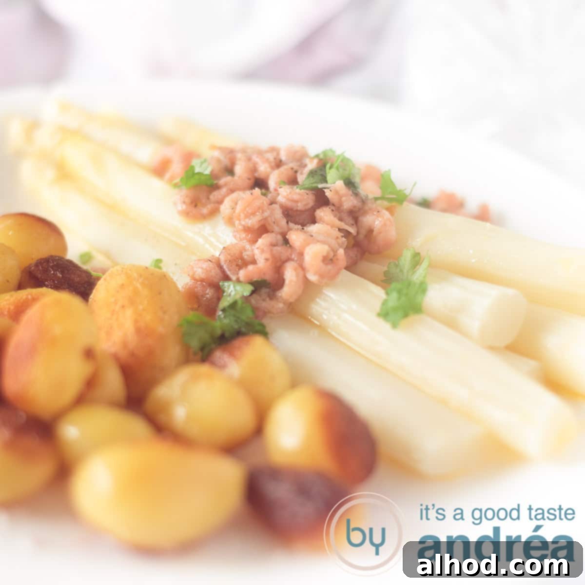 Tender German White Asparagus with Melted Butter 6 A square picture of a white plate with potatoes asparagus, shrimp butter sauce