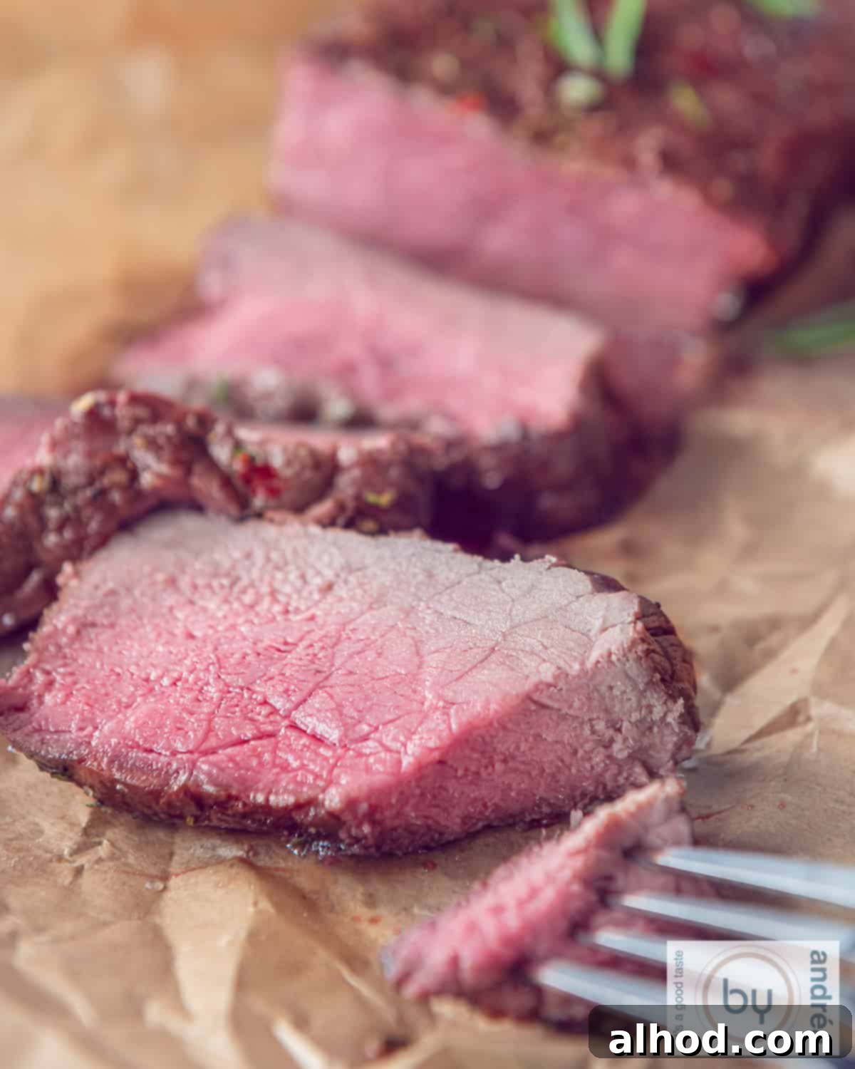 Slow-Roasted Herb-Crusted BBQ Beef 2 A perfectly cooked roast beef with three slices expertly cut, revealing its tender, pink interior.