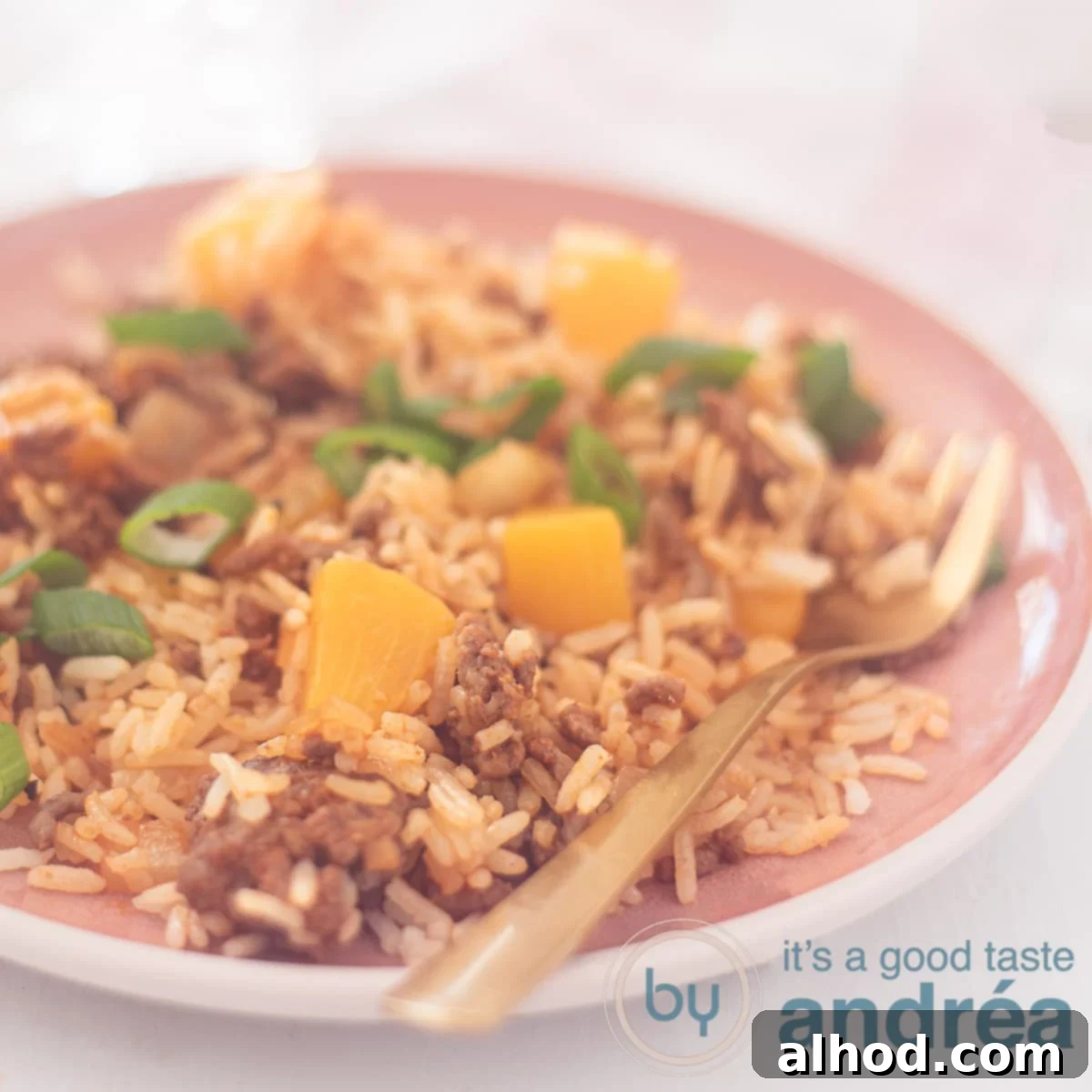 Sweet and Savory Beef Peach Pilaf 6 A square photo with rice, minced meat and peach on a pink plate
